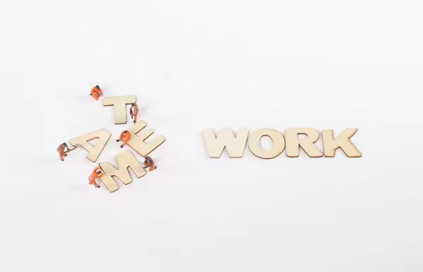 Miniature workers with Team Work text