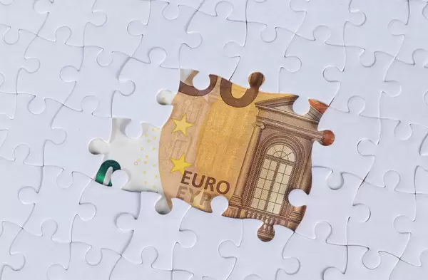 Missing jigsaw puzzle pieces on 50 Euro money banknote