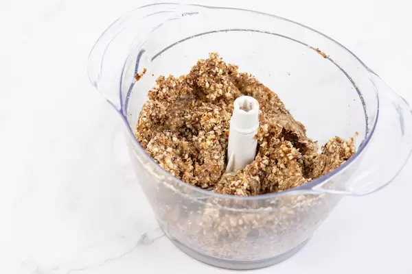 Mixture for Energy Balls with Date Palm fruits Almonds and Hazelnuts in the bowl