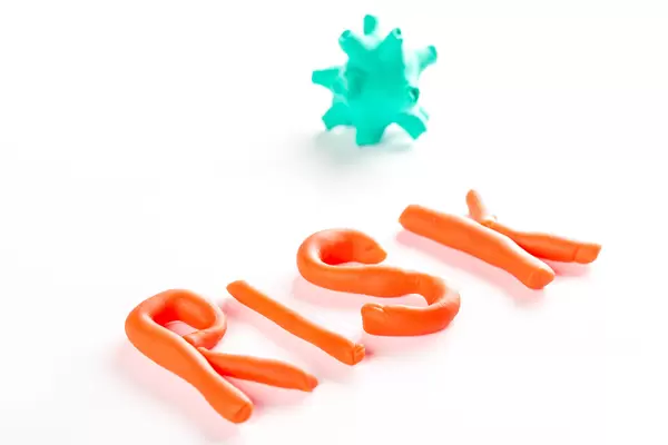 Model of coronavirus made from plasticine and inscriptions risk