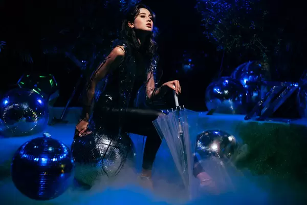 Model posing in the fairy-tale setting with disco balls and fog at Berlin Photo Week