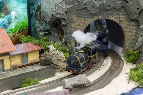 Model railroad. Train going through a tunnel
