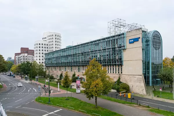 Modern architecture WDR building in Düsseldorf: classical stone foundation with glass facade