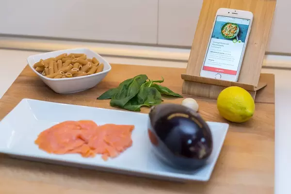 Modern Cooking concept with vegetables and a recipe on the smartphone