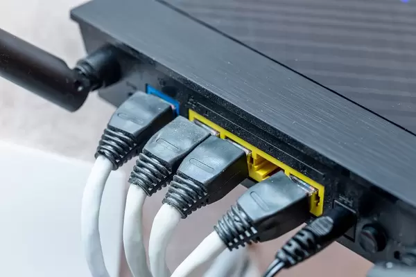 Modern wireless wi-fi router with wires connected close up (Flip 2019)