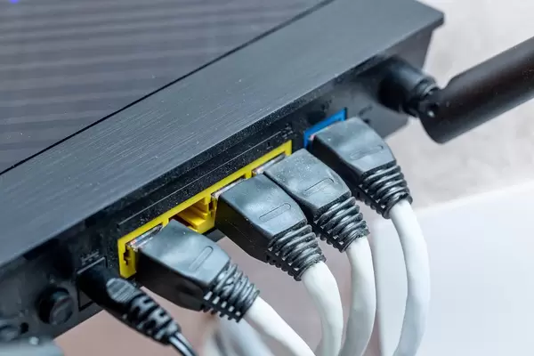 Modern wireless wi-fi router with wires connected close up