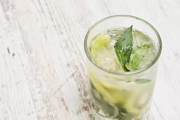 Mojito cocktail or non-alcohol drink with mint and sliced kiwi fruits
