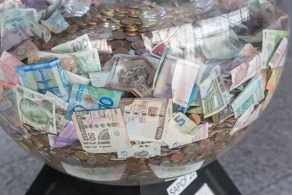 Money from around the world in one big transparent bowl