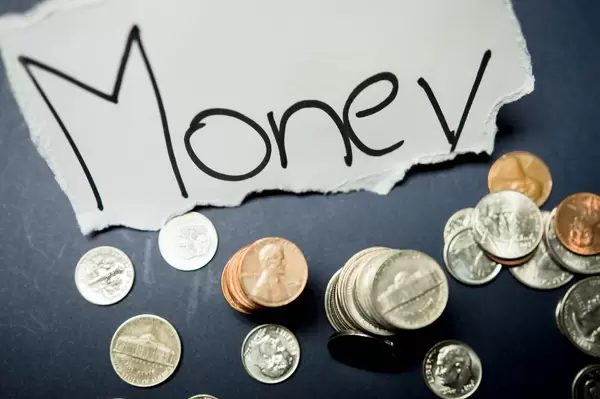 MONEY tag with coins around it