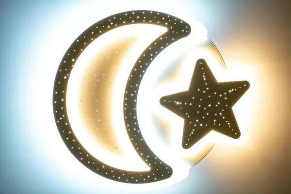 Moon and star chandelier in a baby's bedroom