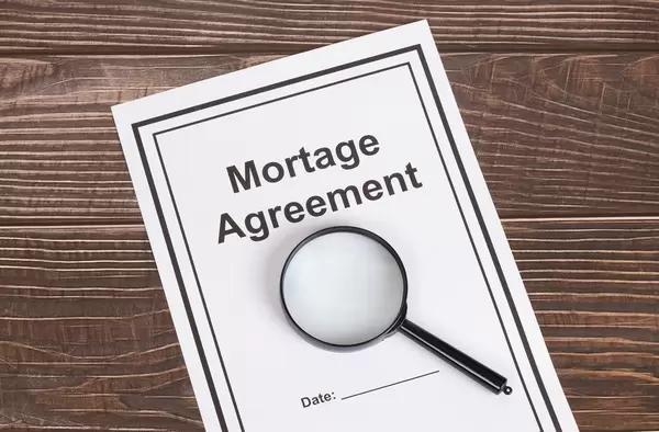 Mortage Agreement document with magnifying glass