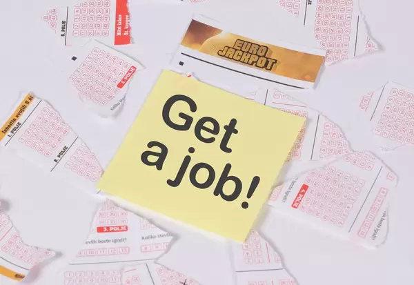 Motivation sticker note on teared up lottery tickets