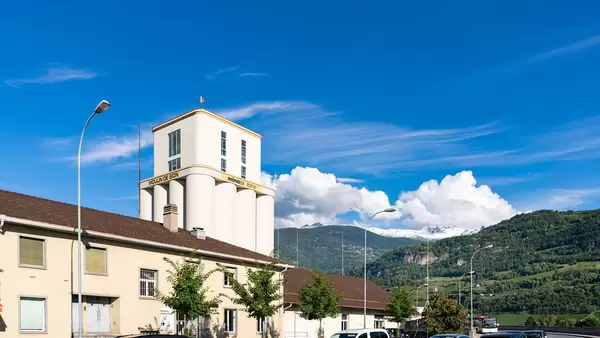 Moulin de Sion building with mountainous backdrop