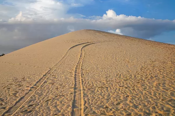 Mountain in the White Sand Dunes with a Cloudy Sky in Mui Ne