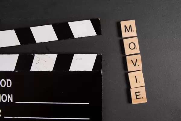 Movie clapper with Movie text on black background