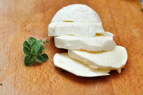 Mozarella sliced on a cutting board