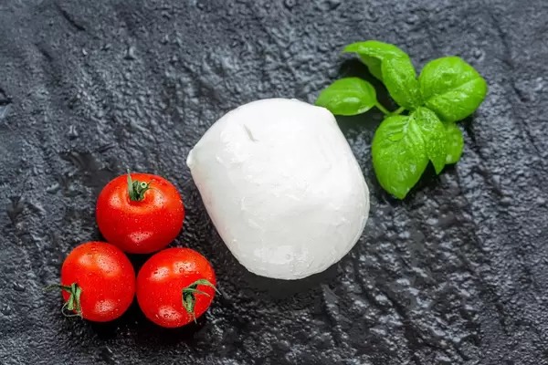 Mozzarella-cherry-tomatoes-and-Basil-leaves-on-black-stone-background.jpg