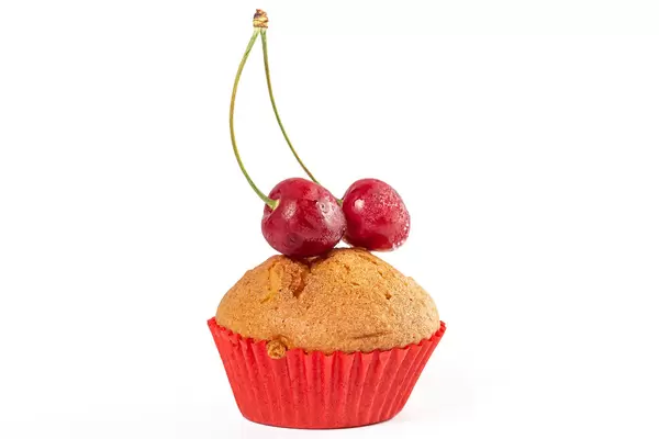 Muffins with cream filling and ripe cherries