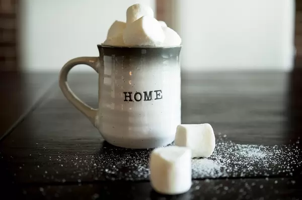 Mug with marshmallows on wooden table
