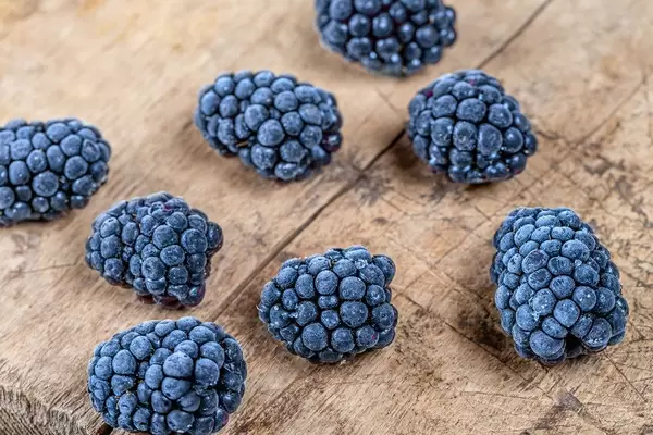 Mulberry berries on an old wooden background. Top view (Flip 2020)