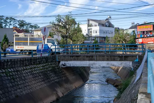 Mulitple Electricity Power Lines across a Canal connecting Houses in the City Center of Da Lat, Vietnam