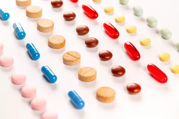 Multi-colored capsules and tablets, medical background