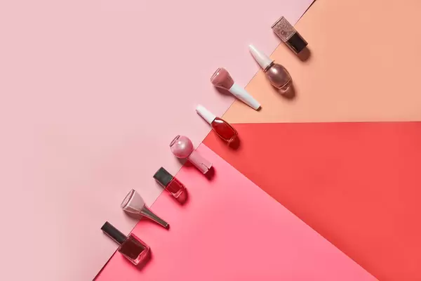 Multi-colored nail polish on pastel-colored geometric pattern background