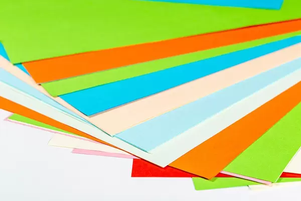 Multi colored paper on white background
