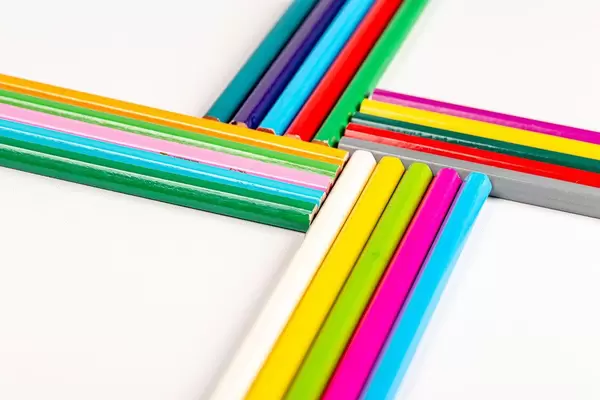 Multi-colored pencils on white background