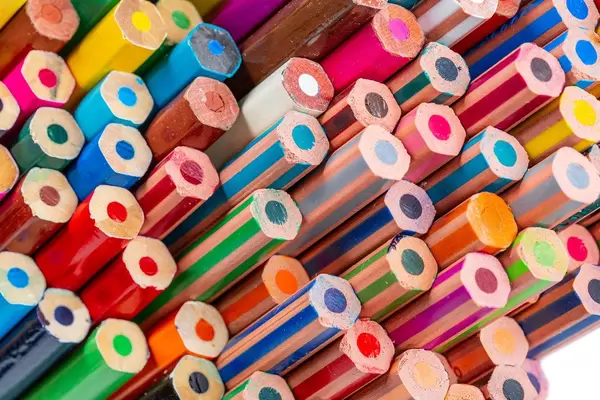 Multi colored pencils. School background