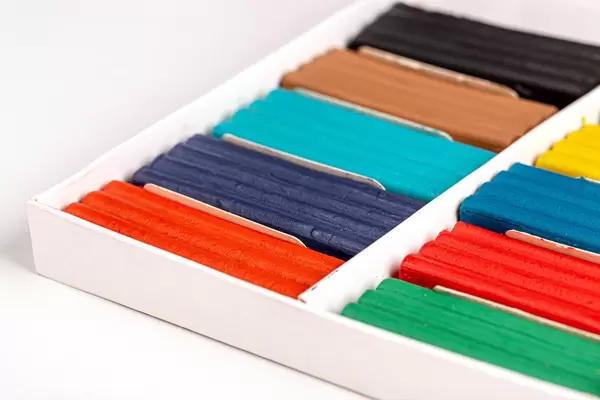 Multi-colored plasticine in a cardboard box, close-up
