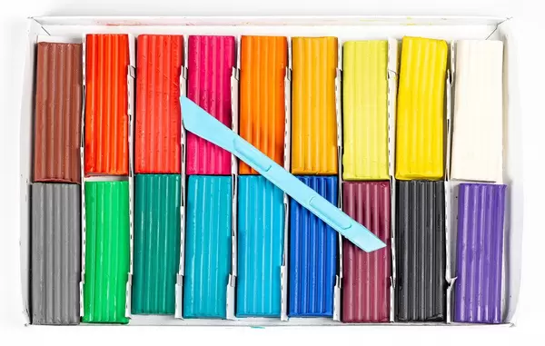 Multi- colored plasticine on a white background, top view (Flip 2020)