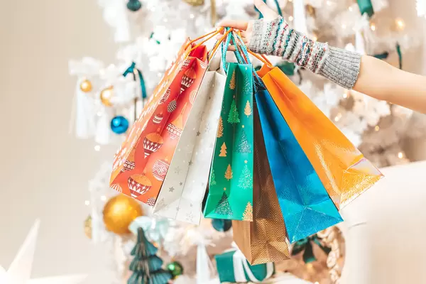 Multicolored gift bags in hand