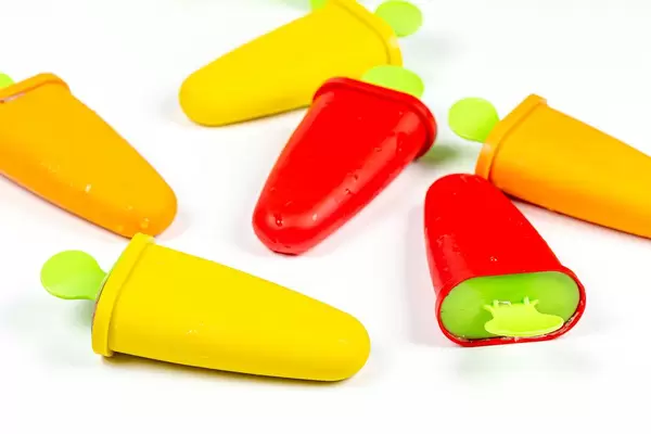 Multicolored ice cream makers form with sticks on white background