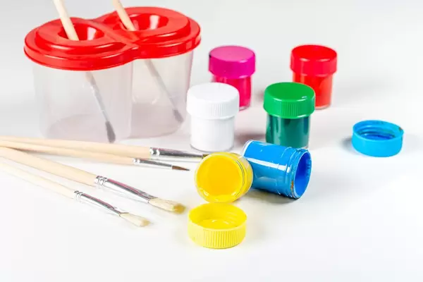 Multicolored paints and brushes on a white background (Flip 2020)