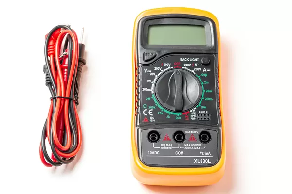 Multimeter with probes on white