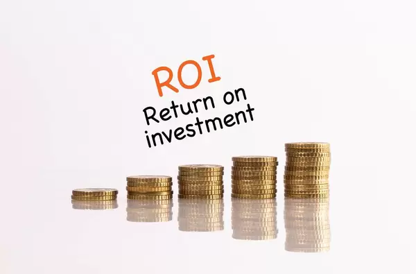Münzstapel mit dem Text ROI - Return on investment (Kapitalrendite)