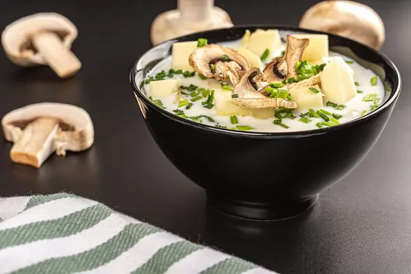 Mushroom soup in a black bowl