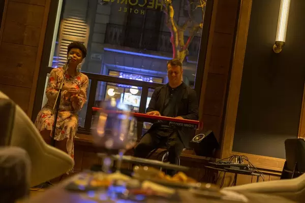 Music duo with keyboard on small stage in the bar of The Corner Hotel in Barcelona, Spain
