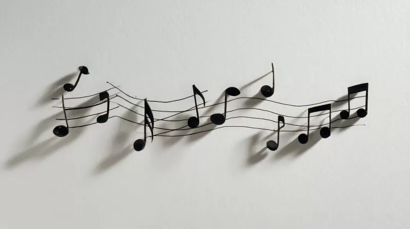 Musiknoten auf weißem Papier mit Schattenwurf