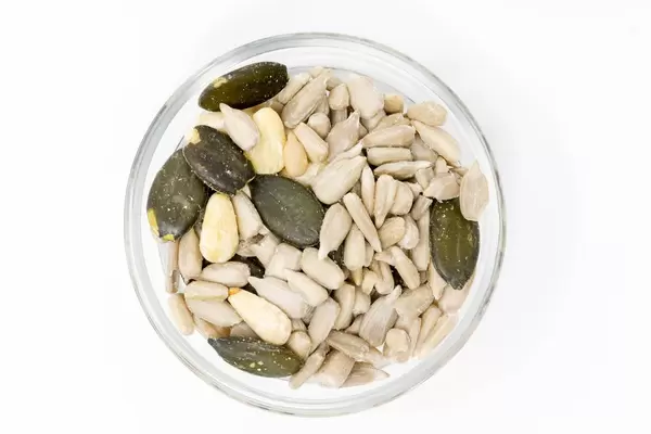 Nahaufnahme von kerniger Mischung - Sonneblumen, Pinien und Kürbiskerne in Glasschälchen