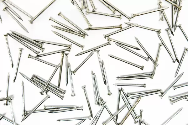 Nails spread out on a white surface  Flip 2019