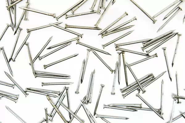 Nails spread out on a white surface