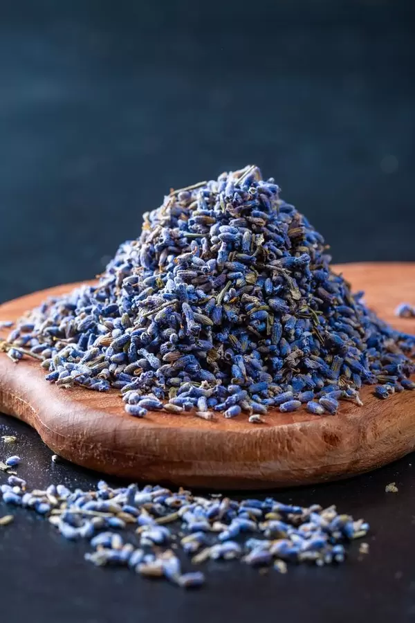 Natural dry lavender flowers tea on wooden board
