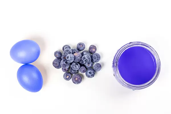 Natural easter eggs dyeing with blueberries, top view
