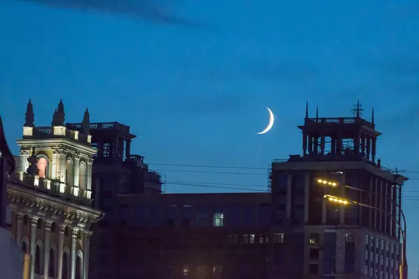 New moon above the rooftops of Moscow