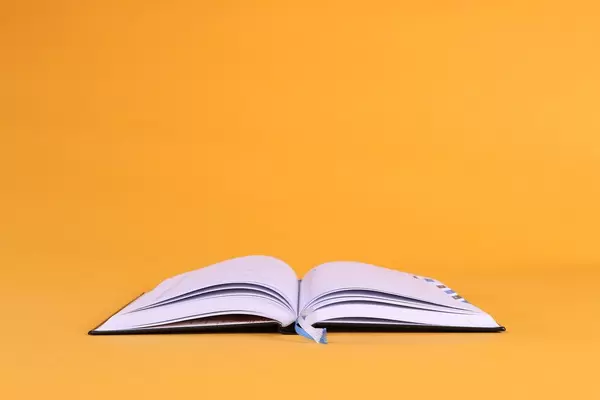 New open book on orange background