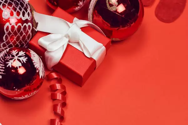 New year background on red with decorative toys and present box