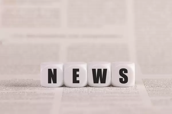 News written with cubes on a newspaper