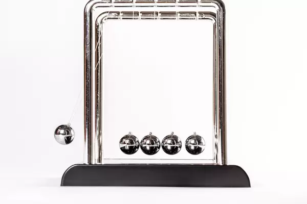 Newton's metal balls on a white background, business concept